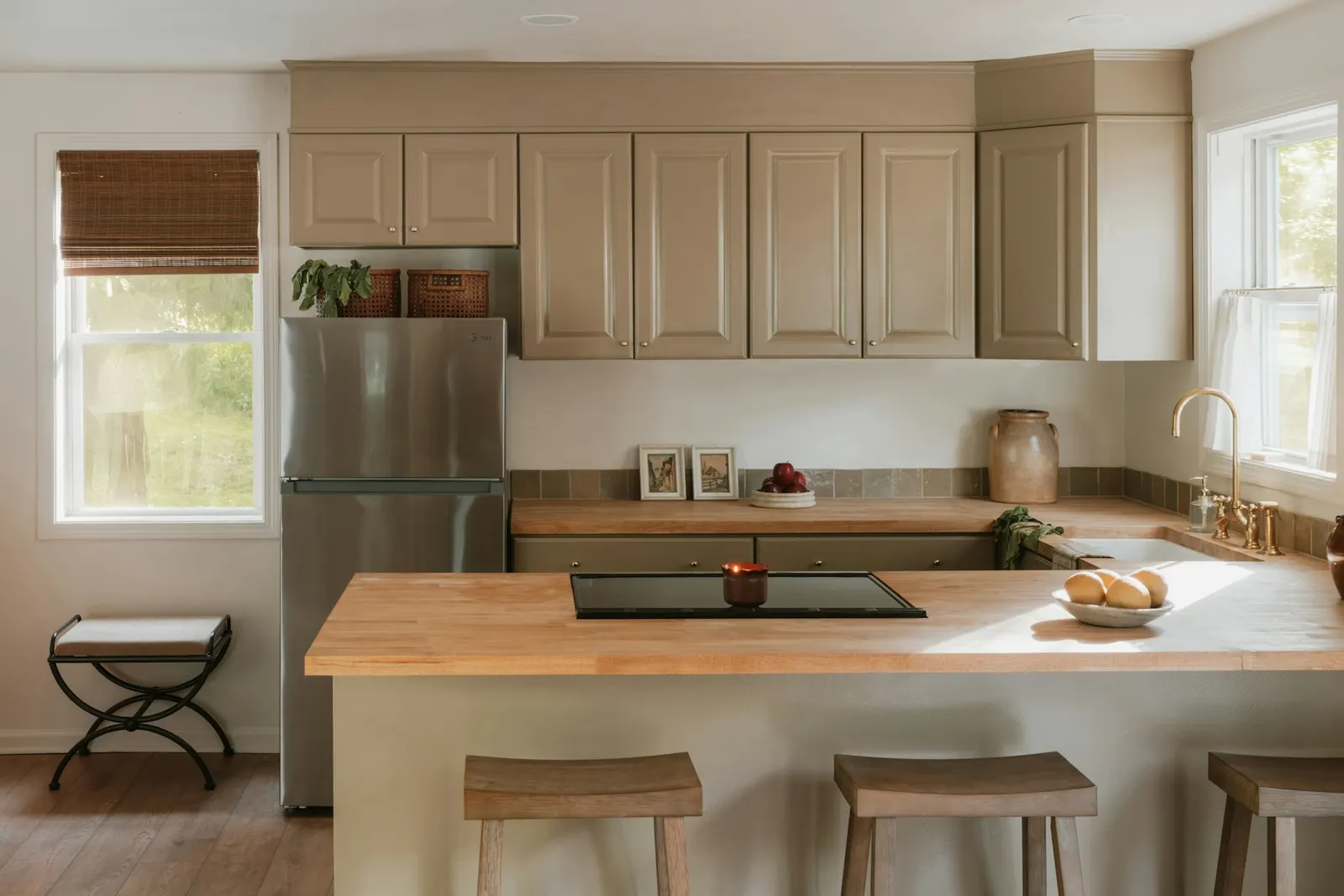 A bright, clean, lived-in kitchen with clear counters and daylight through the window